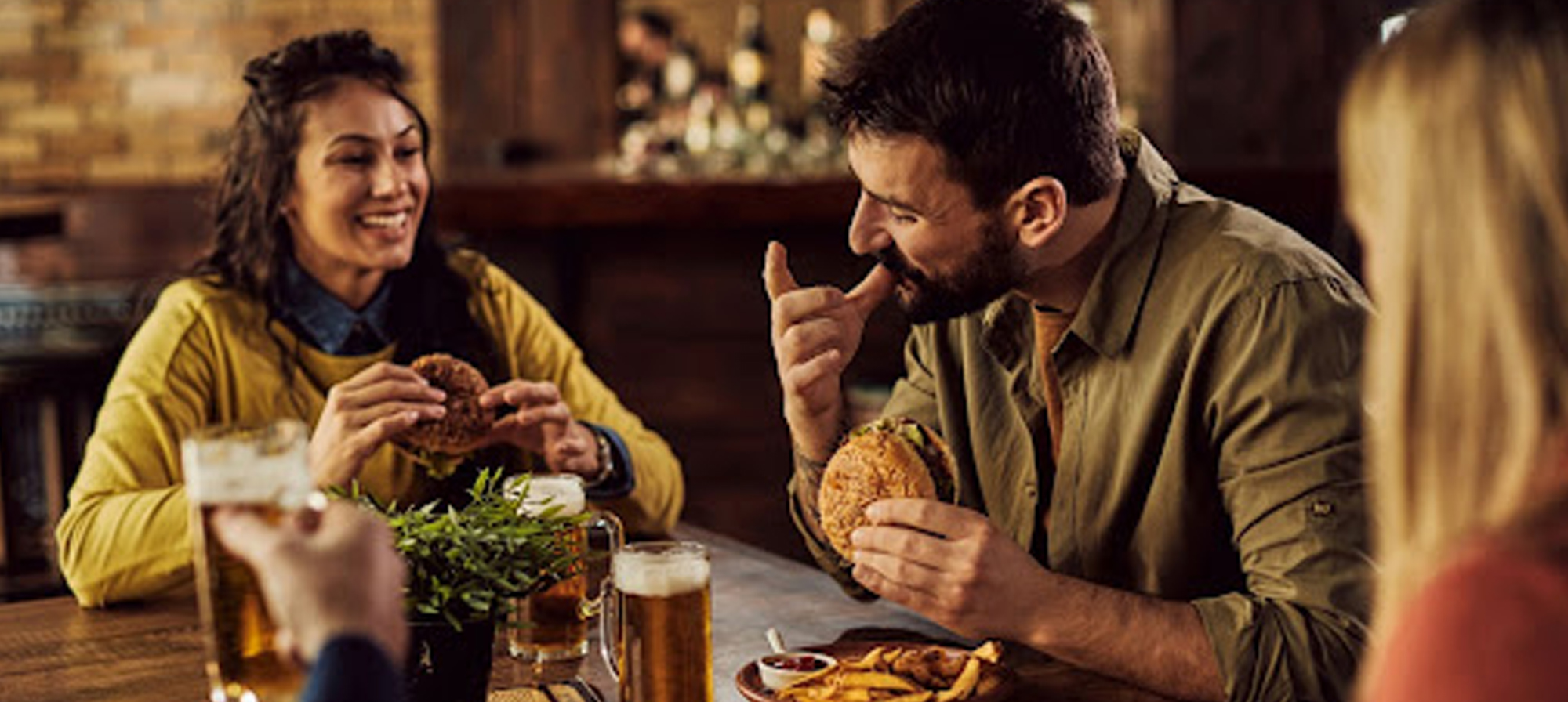 couple eating a hamburger at a restaurant