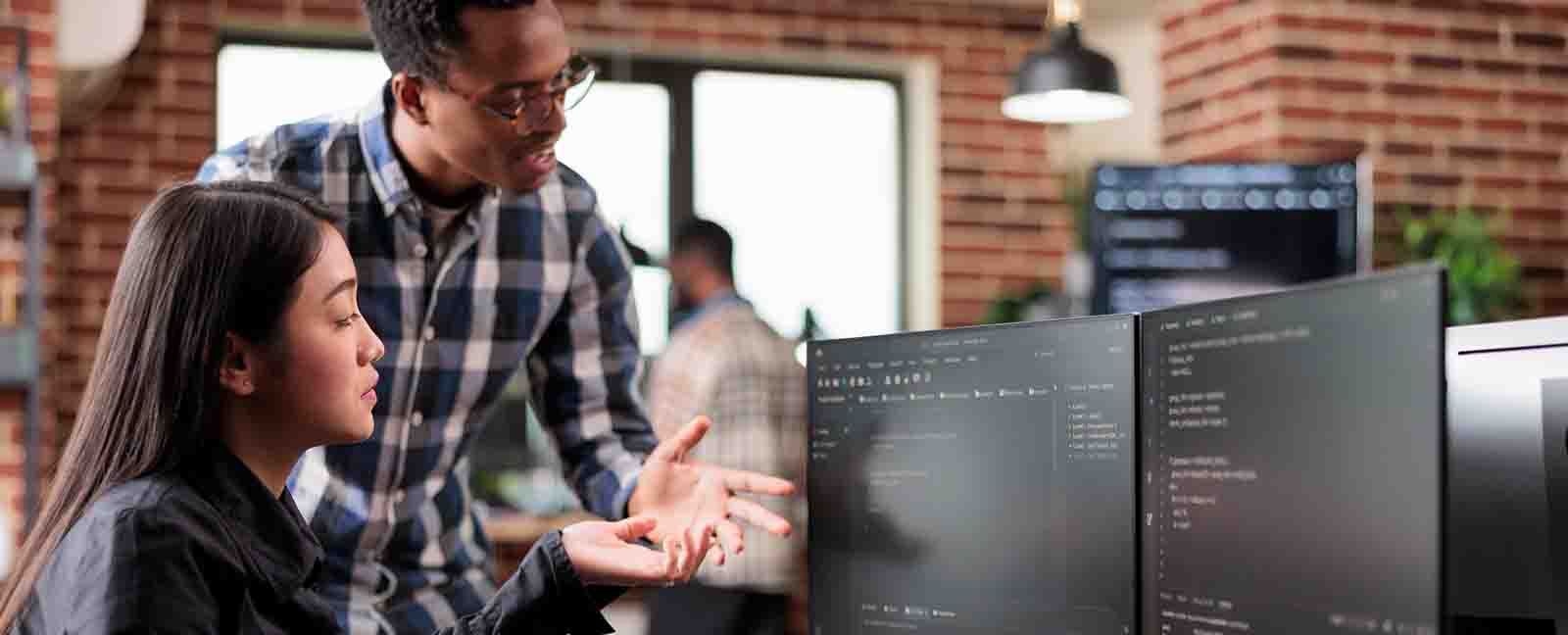 Two business people looking at a computer.