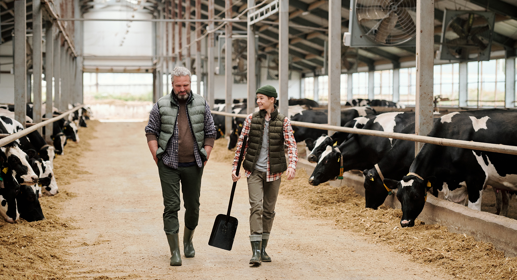 Farmers walking through barn