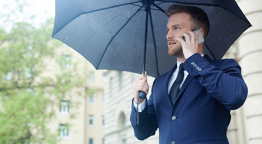 Business man holding an umbrella